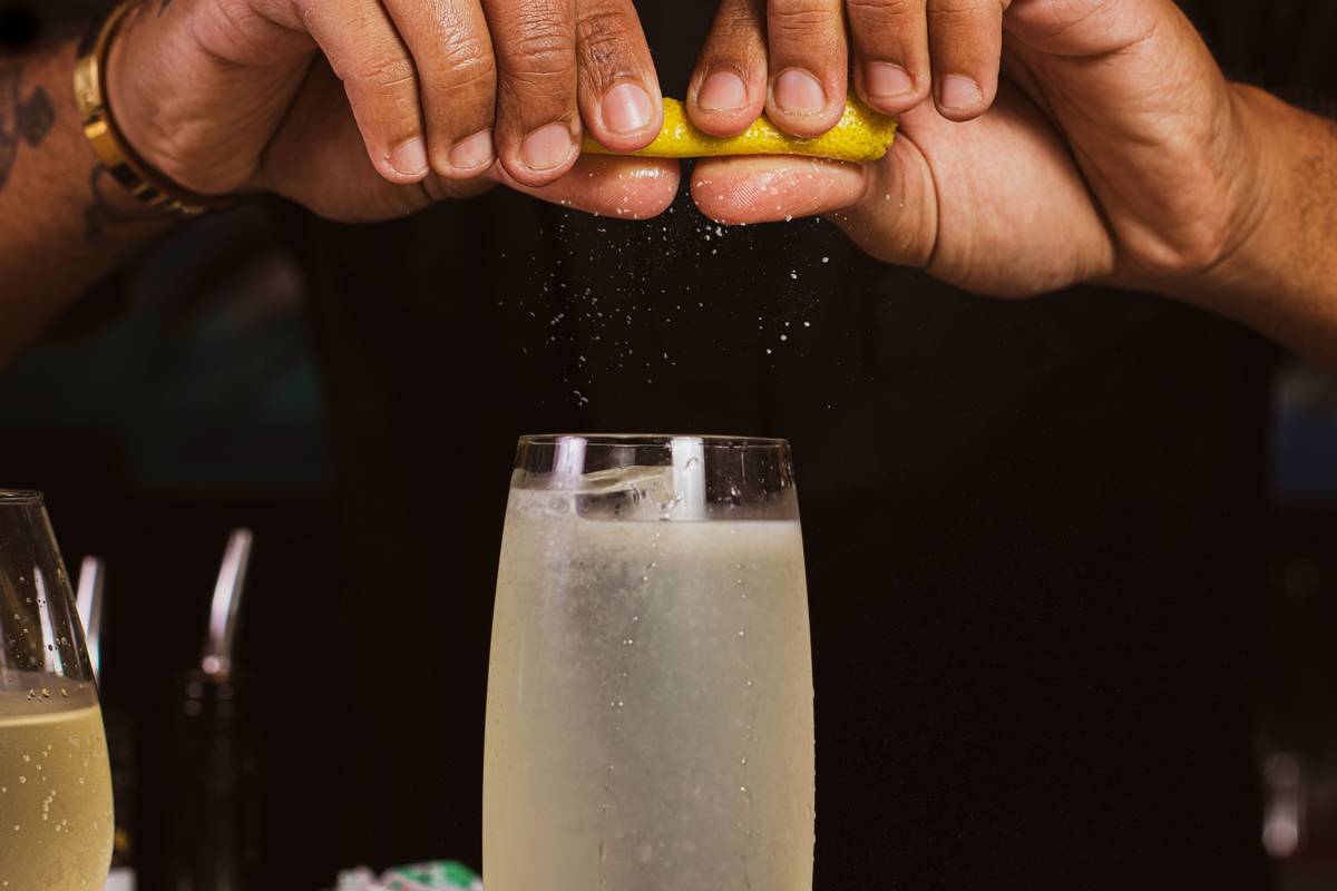 how to use a zester on a lemon showing fine yellow zest without white pith