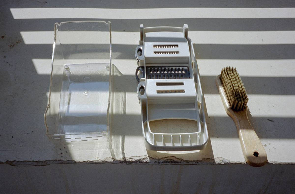 how to clean a zester with a toothbrush and baking soda on a kitchen counter